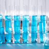 Close-up of blue liquid in test tubes for chemistry experiments in a laboratory setting.